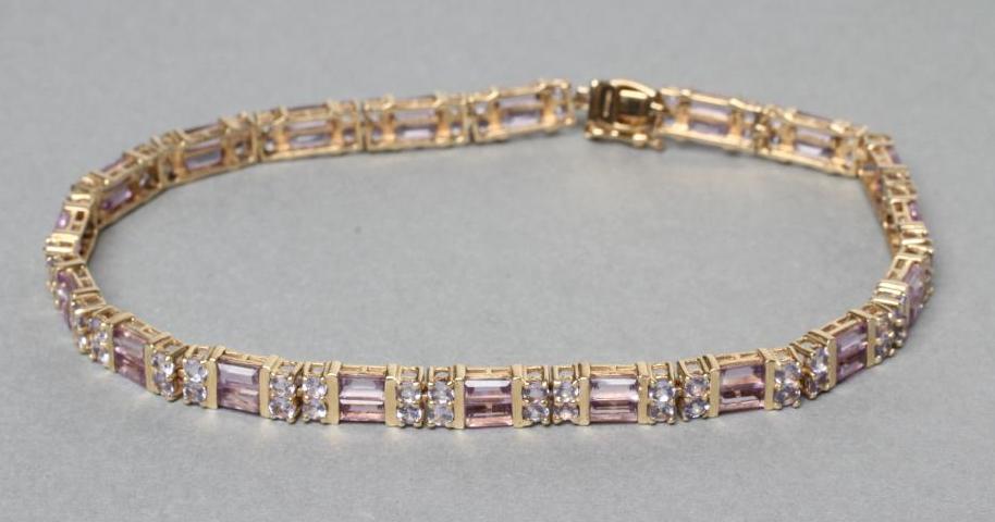 A GEM SET BRACELET with nineteen pairs of baguette cut pink stones alternating with eighteen point Image