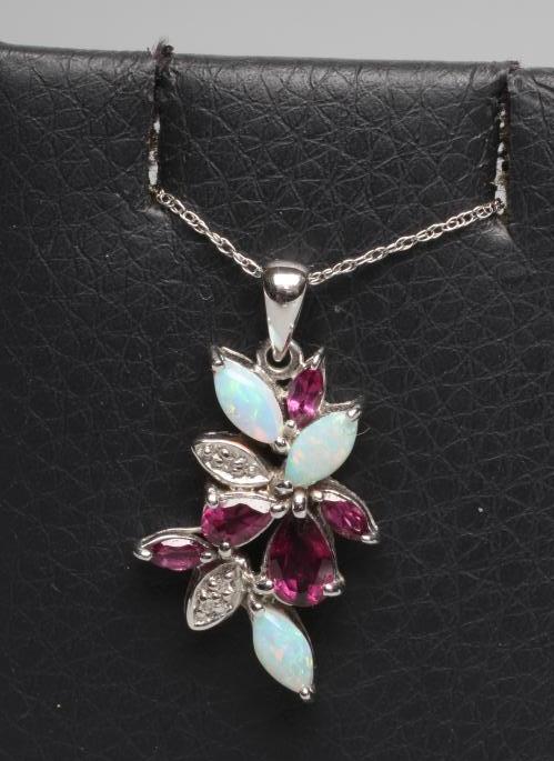 AN ALMANDINE GARNET AND OPAL ABSTRACT PENDANT set with five pear and other cut garnets and three Image