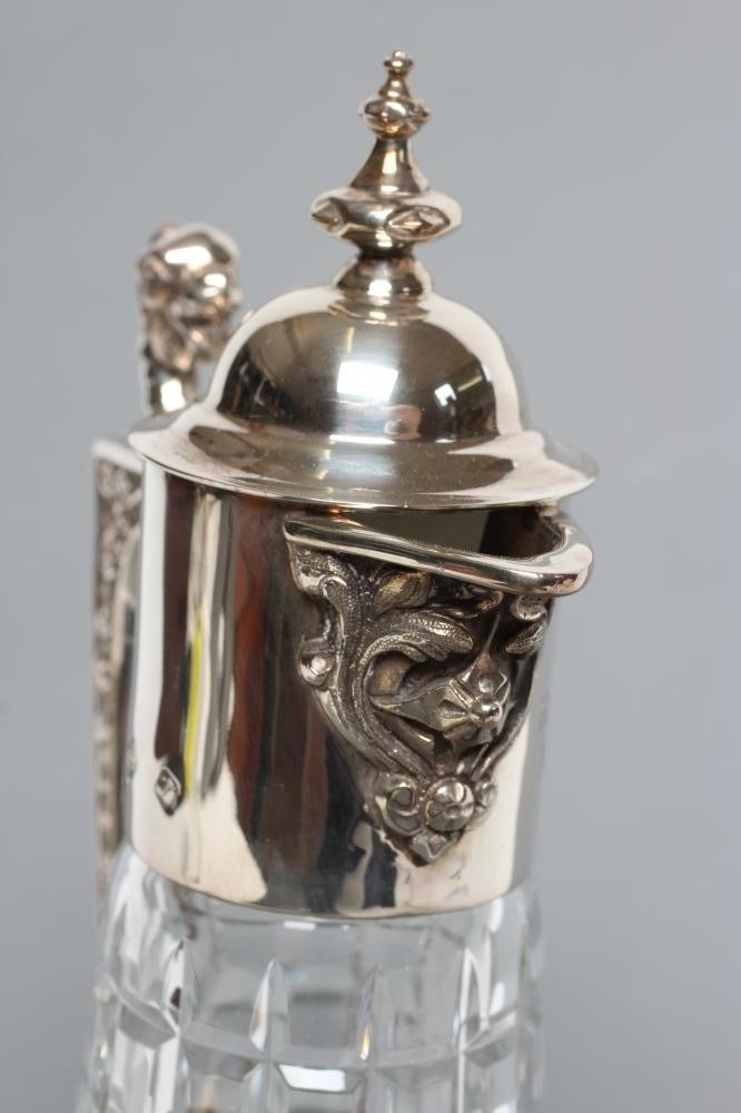 A SILVER MOUNTED CLARET JUG Image