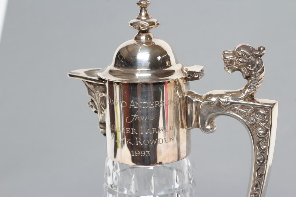 A SILVER MOUNTED CLARET JUG Image