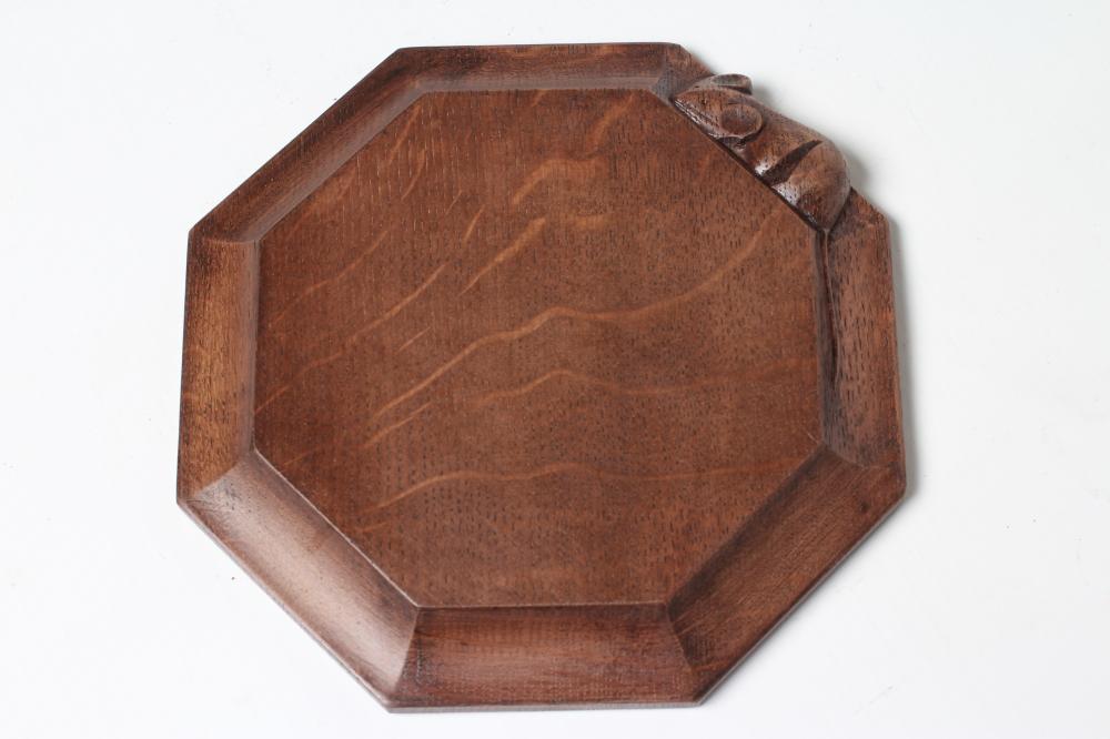 A ROBERT THOMPSON ADZED OAK TEAPOT STAND/CHOPPING BOARD of octagonal form Image