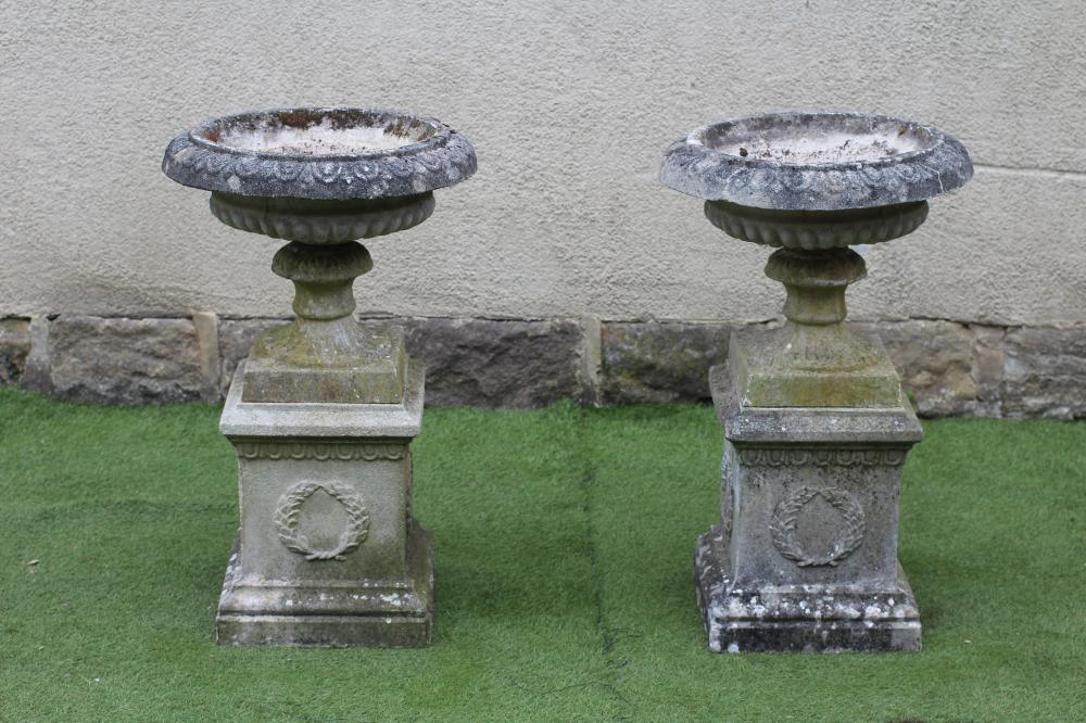 A PAIR OF COMPOSITION STONE URNS Image