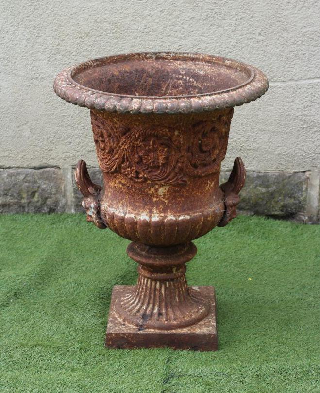 A VICTORIAN CAST IRON URN of half fluted campana form with beaded rim and mask loop handles Image