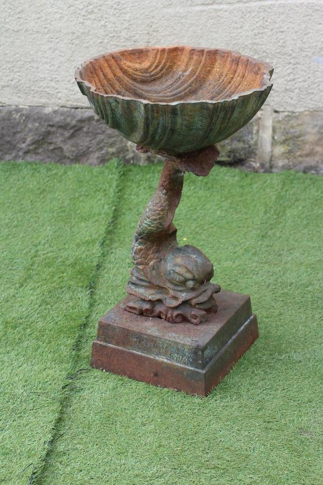 A CAST IRON PLANTER modelled as a dolphin supporting a scallop shell Image