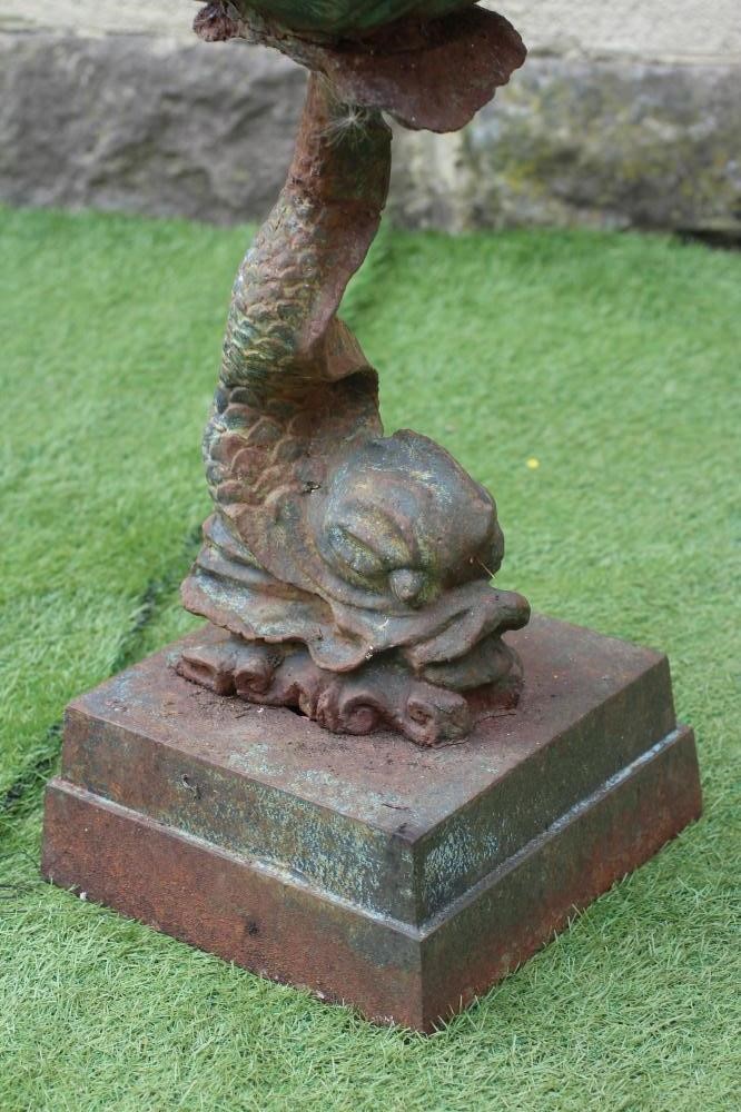 A CAST IRON PLANTER modelled as a dolphin supporting a scallop shell Image