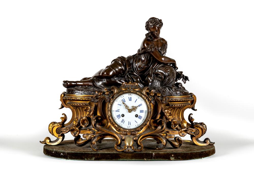 A FRENCH PATINATED AND GILT BRONZE MANTEL CLOCK Image