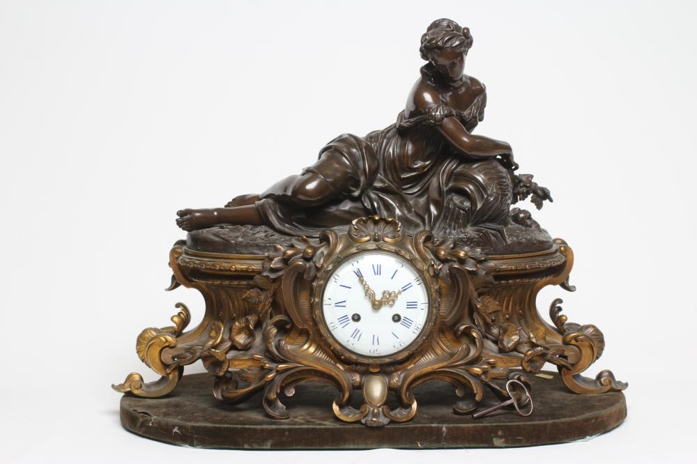 A FRENCH PATINATED AND GILT BRONZE MANTEL CLOCK Image