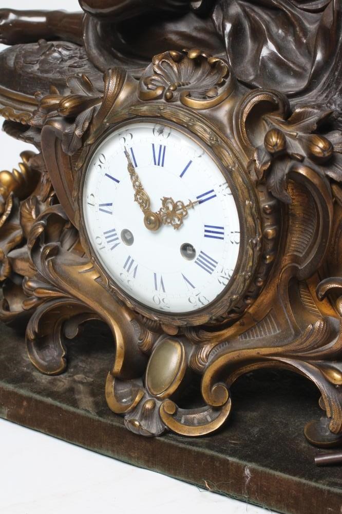 A FRENCH PATINATED AND GILT BRONZE MANTEL CLOCK Image
