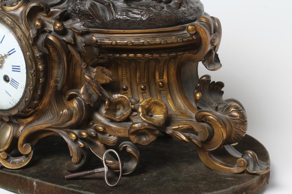 A FRENCH PATINATED AND GILT BRONZE MANTEL CLOCK Image