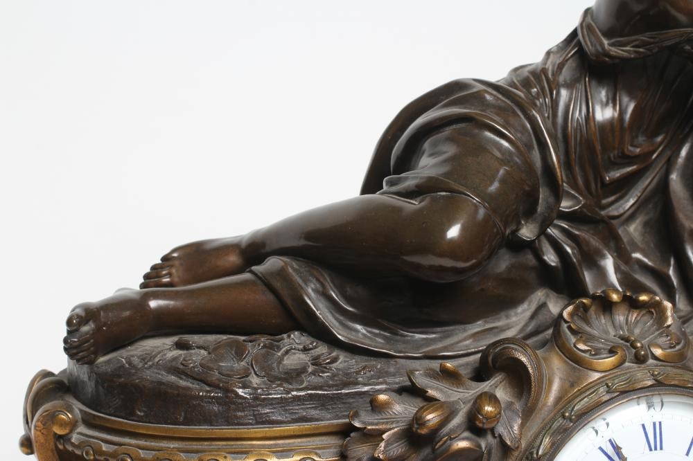 A FRENCH PATINATED AND GILT BRONZE MANTEL CLOCK Image