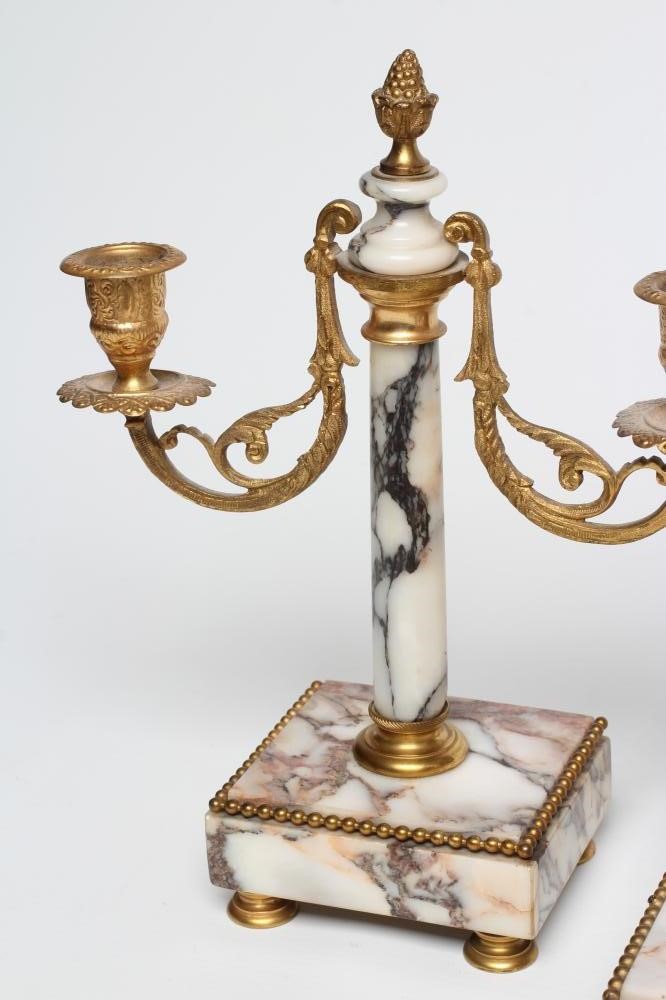 A FRENCH VEINED WHITE MARBLE AND GILT METAL PORTICO GARNITURE Image