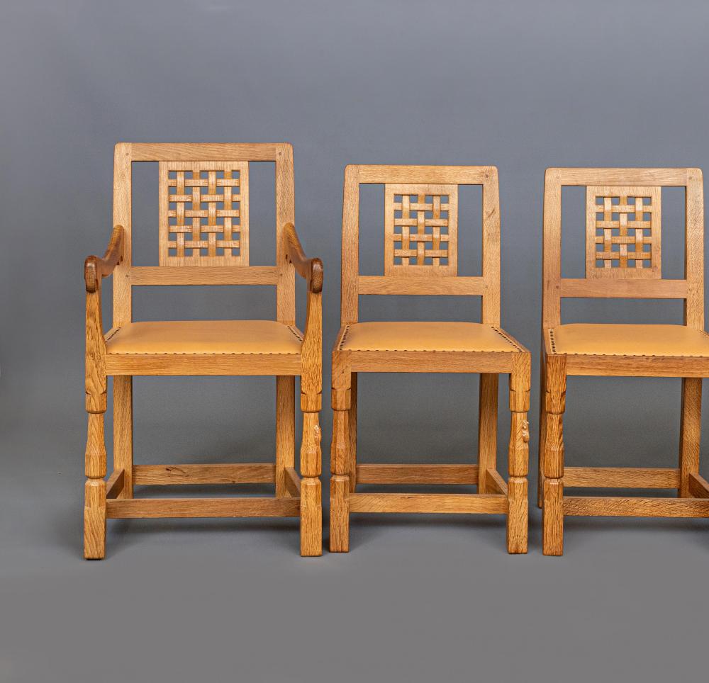 A SET OF SIX ROBERT THOMPSON OAK DINING CHAIRS including two elbow chairs Image