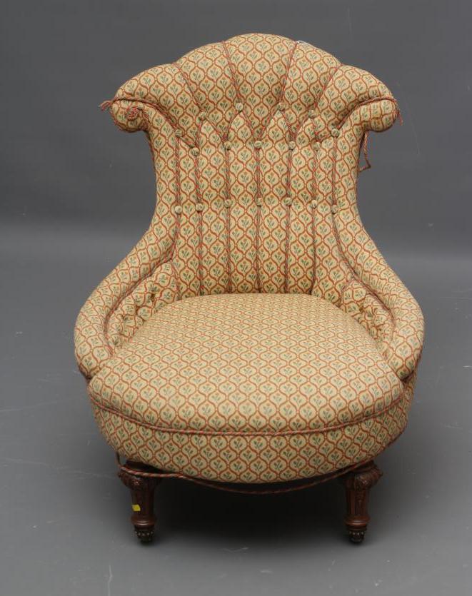 A VICTORIAN WALNUT FRAMED NURSING CHAIR button upholstered in a cream Image