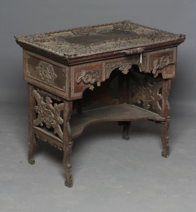 AN INDIAN KASHMIRE MERCHANT'S HARDWOOD KNEEHOLE DESK of oblong form profusely carved in high and low Image