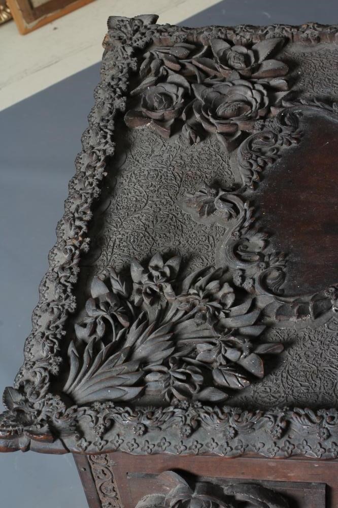 AN INDIAN KASHMIRE MERCHANT'S HARDWOOD KNEEHOLE DESK of oblong form profusely carved in high and low Image