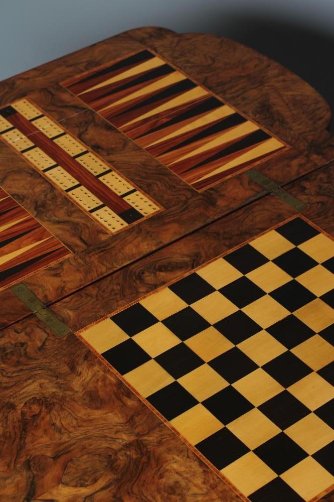 A VICTORIAN BURR WALNUT GAMES/WORK TABLE of shaped oblong form with stringing and foliate marquetry Image