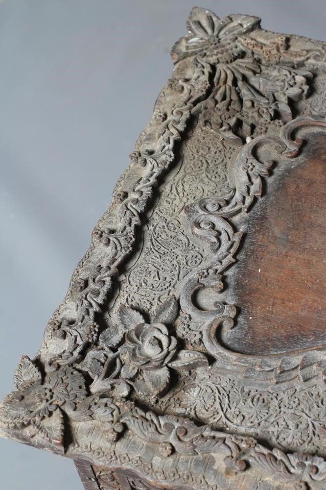 AN INDIAN CARVED HARDWOOD WORK TABLE(?) of low oblong form Image