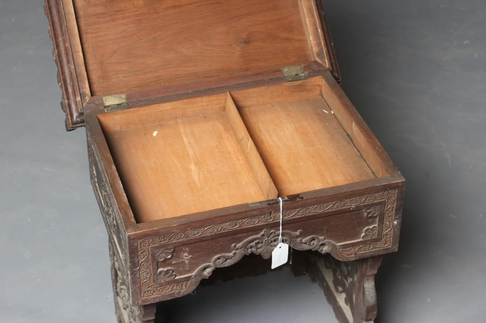 AN INDIAN CARVED HARDWOOD WORK TABLE(?) of low oblong form Image