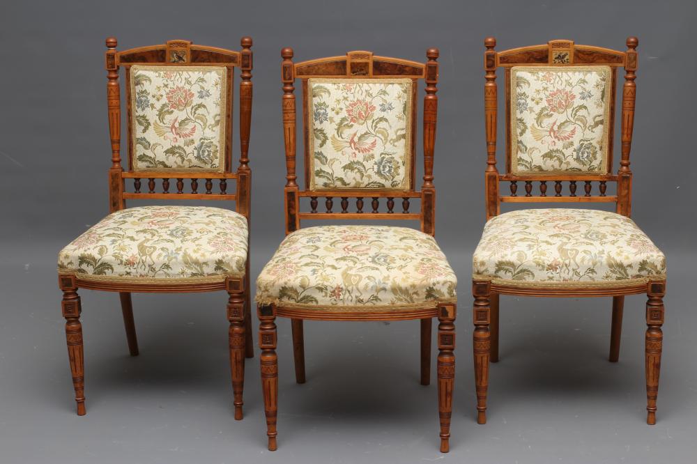 A SET OF THREE VICTORIAN AESTHETIC SATINWOOD SALON SIDE CHAIRS upholstered in an ivory ground floral Image