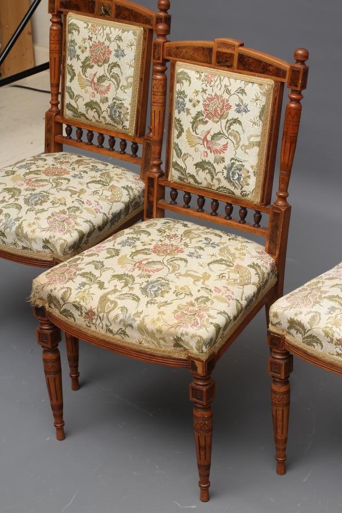 A SET OF THREE VICTORIAN AESTHETIC SATINWOOD SALON SIDE CHAIRS upholstered in an ivory ground floral Image