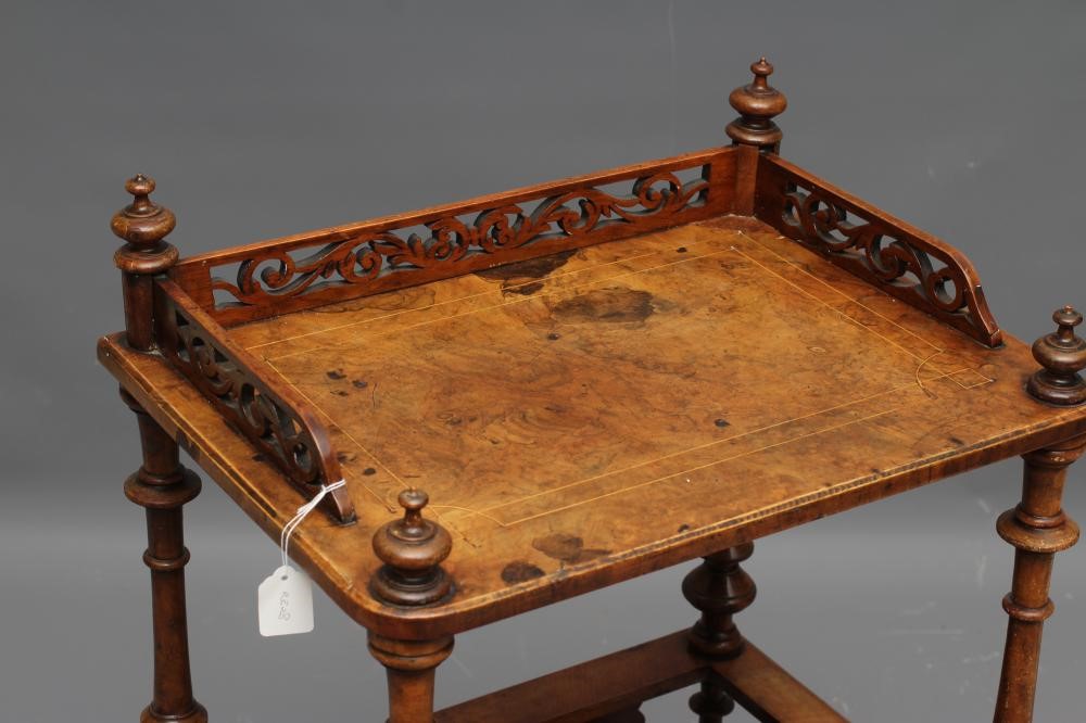 A VICTORIAN WALNUT CANTERBURY/WHATNOT of rounded oblong form with stringing and foliate marquetry Image