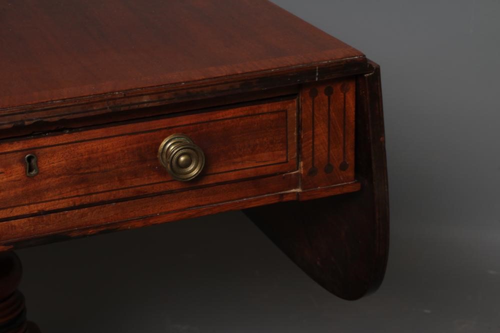 A REGENCY MAHOGANY PEMBROKE TABLE of rounded oblong form with stringing Image