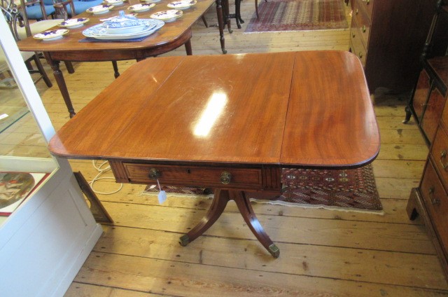 A REGENCY MAHOGANY PEMBROKE TABLE of rounded oblong form with stringing Image