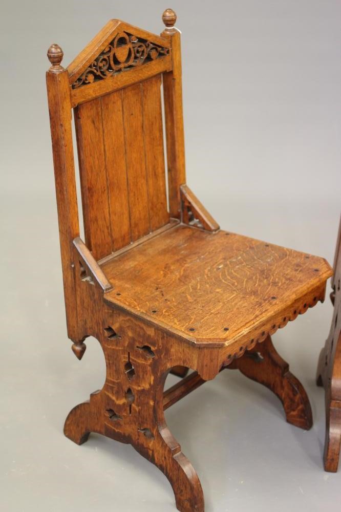 A PAIR OF VICTORIAN GOTHIC OAK AND EBONY INLAID HALL CHAIRS Image