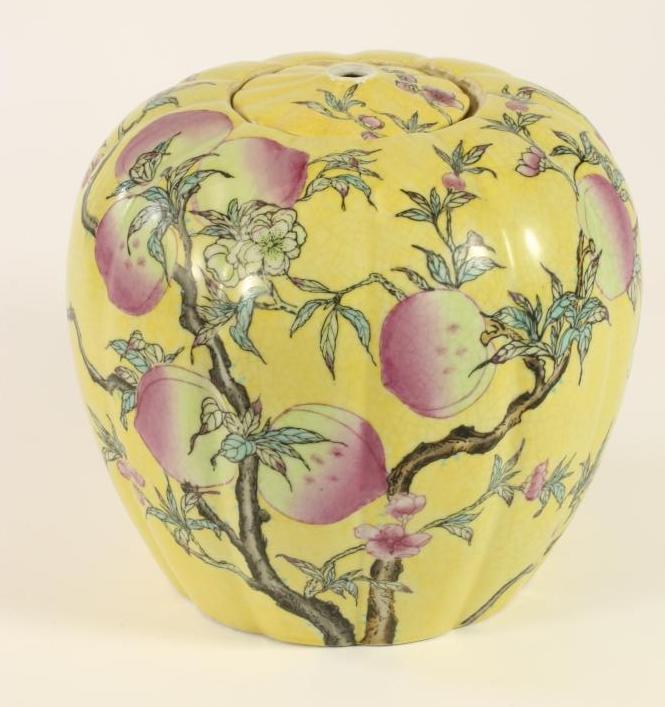 A CHINESE PORCELAIN JAR AND COVER of lobed ovoid form painted with fruiting peach boughs on a yellow Image