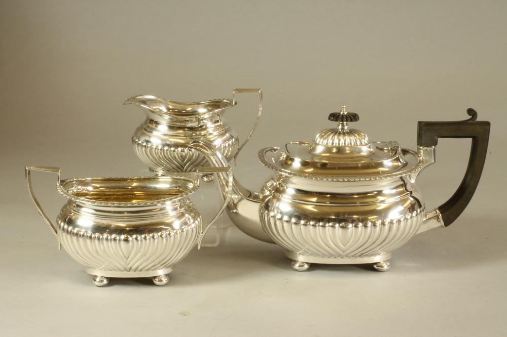 A MATCHED THREE PIECE SILVER TEA SERVICE Image