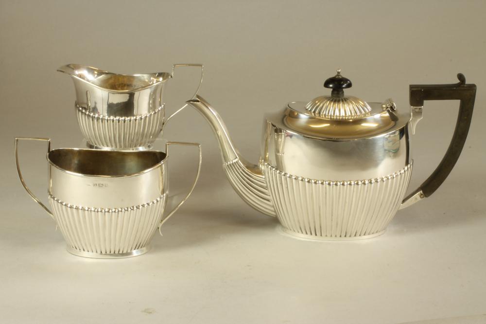 A SILVER THREE PIECE TEA SERVICE Image