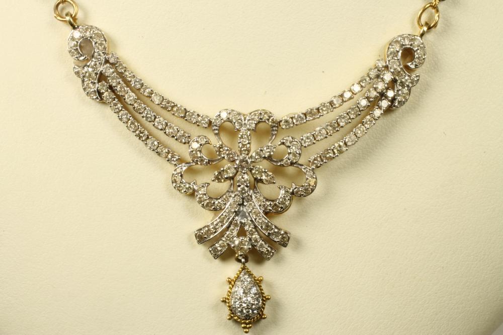 A DIAMOND SET NECKLACE in the Edwardian style with a triple ribbon tied swag centred by a bow and Image