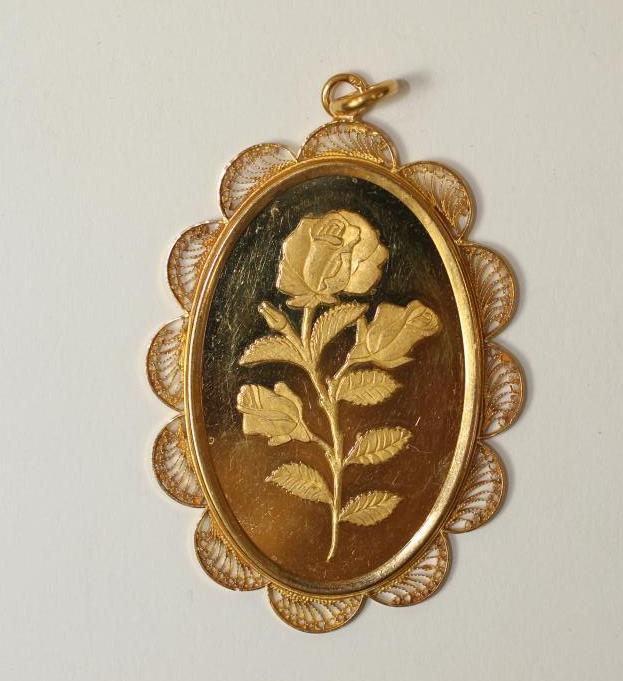 A 23CT GOLD PENDANT of oval form Image