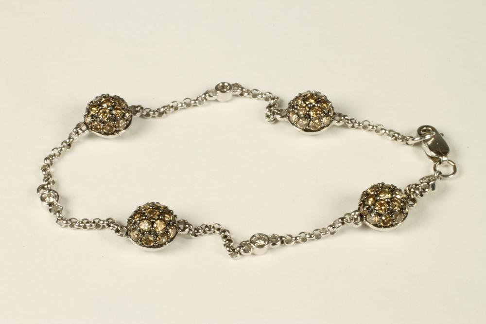 AN 18CT WHITE GOLD BRACELET with four cushion shaped bead spacers Image