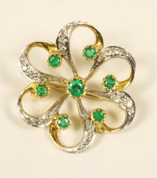 AN EMERALD AND DIAMOND OPEN WHORL BROOCH Image