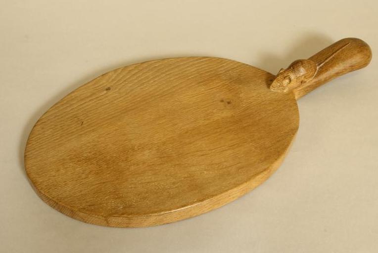 AN ADZED OAK CHEESE BOARD by Robert "Mouseman" Thompson of oval form Image