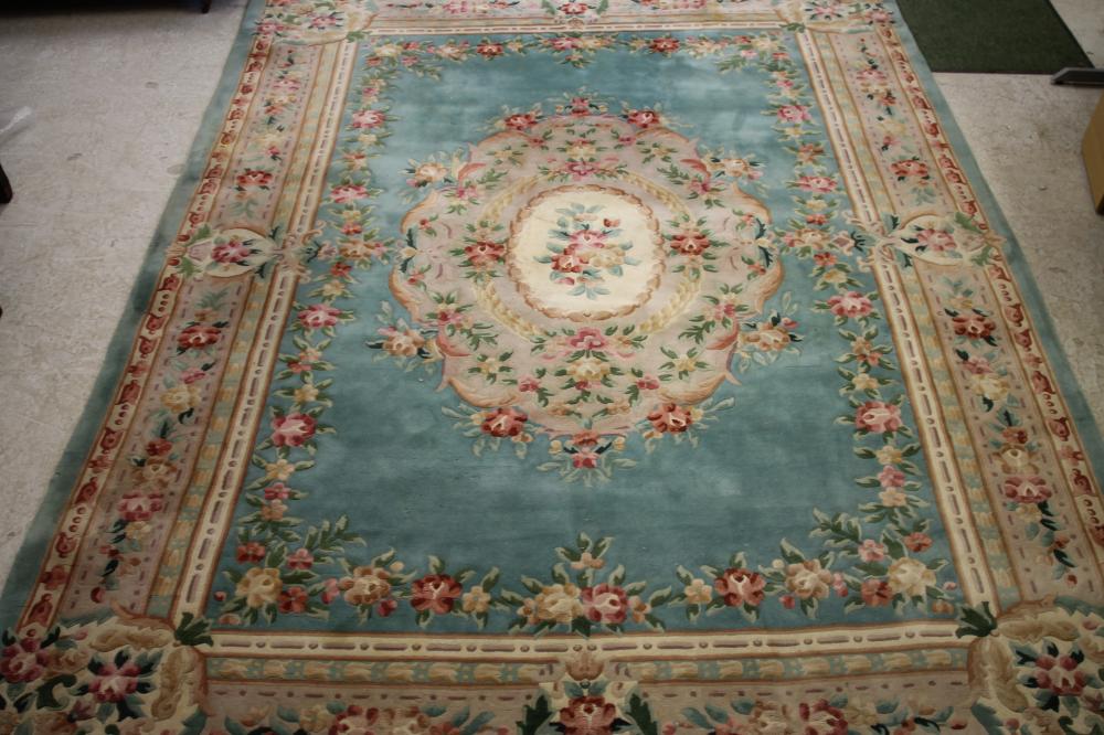 A CHINESE WASHED AND FRINGED CARPET of Aubusson design with pink flowers and two tone green foliage Image