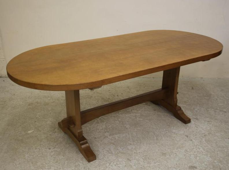 AN ADZED OAK DINING SUITE by Don Craven "Foxman" comprising a table with heavy three plank D ended Image