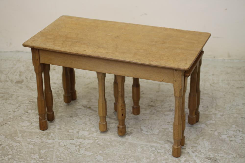 AN ADZED OAK NEST OF TABLES by Don Craven "Foxman" comprising long low oblong table on faceted Image