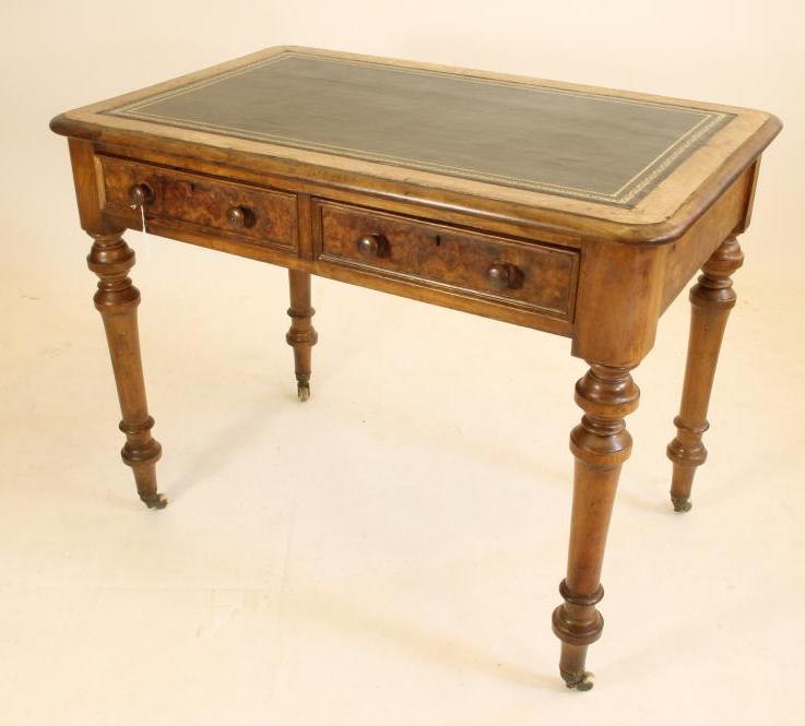 A VICTORIAN WALNUT SMALL LIBRARY TABLE of rounded oblong form with inset green leather top Image