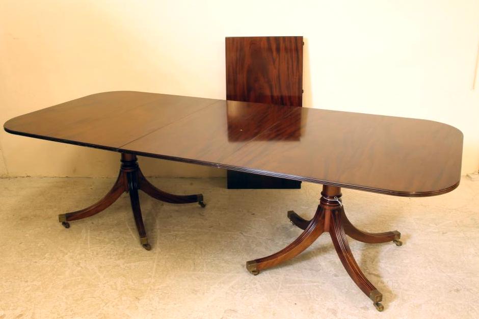 A GEORGIAN STYLE MAHOGANY DINING TABLE by William Tilson Image