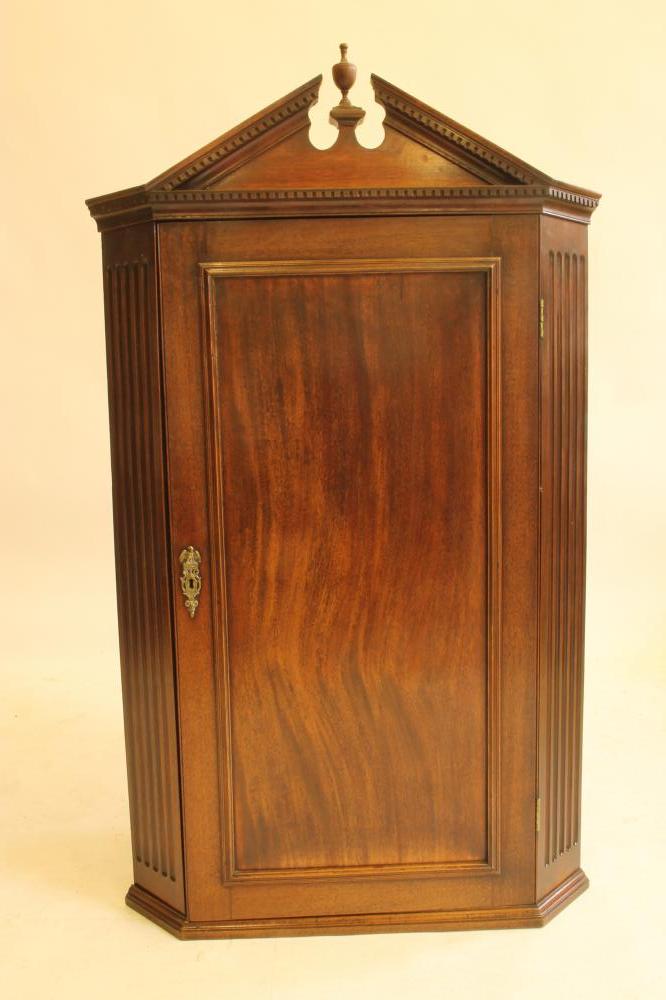A GEORGE III MAHOGANY CORNER CUPBOARD Image