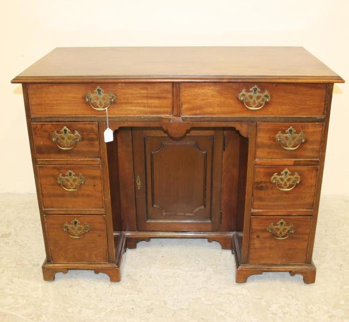A MAHOGANY KNEEHOLE DRESSING TABLE Image