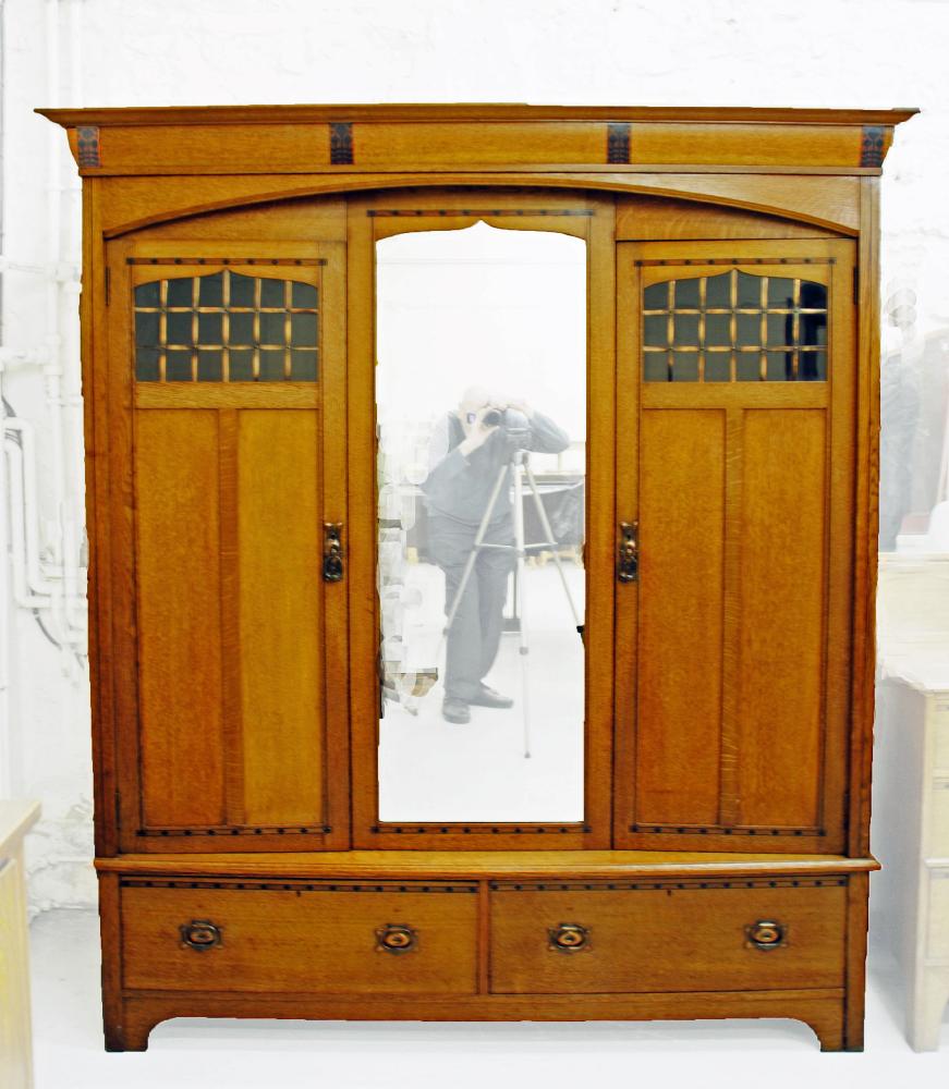 AN ARTS AND CRAFTS OAK PART BEDROOM SUITE with mahogany banding and ebony stringing Image