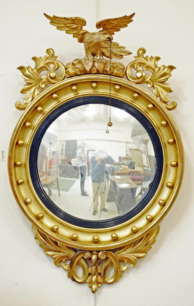 A CARVED GILT WOOD CONVEX MIRROR Image