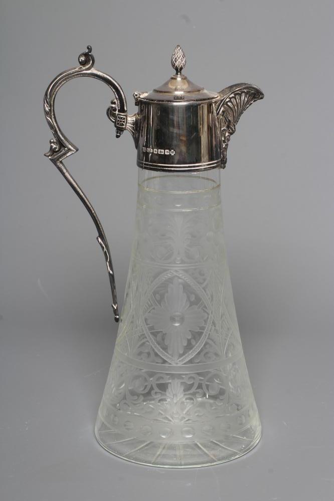 AN ELIZABETH II SILVER MOUNTED GLASS CLARET JUG of swept cylindrical form Image