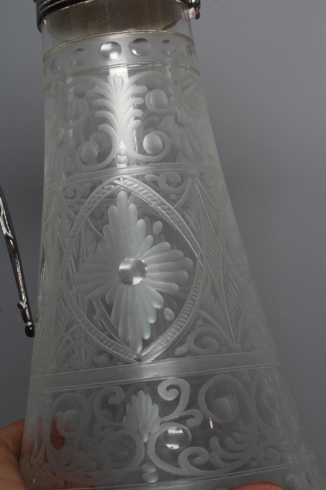 AN ELIZABETH II SILVER MOUNTED GLASS CLARET JUG of swept cylindrical form Image