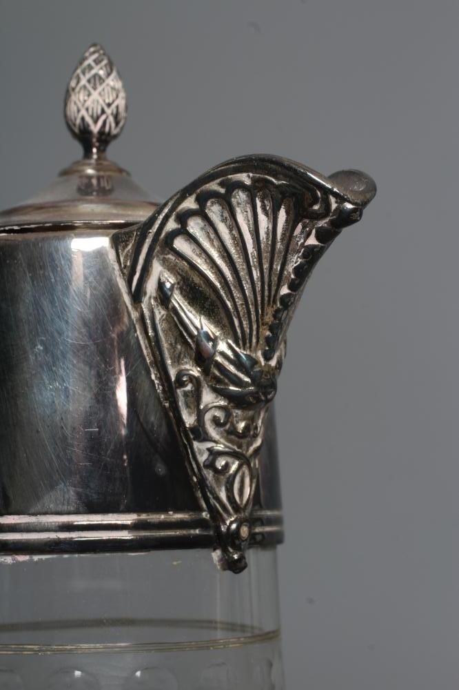 AN ELIZABETH II SILVER MOUNTED GLASS CLARET JUG of swept cylindrical form Image