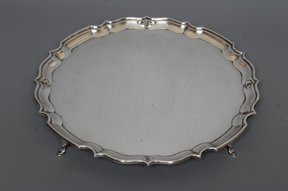 A GEORGE V SILVER SALVER by Barker Bros., Chester 1923, of shaped circular form with pi-crust rim, Image