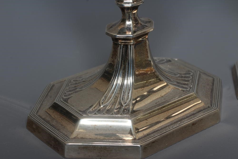 A COMPOSITE PAIR OF GEORGE V SILVER CANDLESTICKS by Harrison Bros. & Howson Image